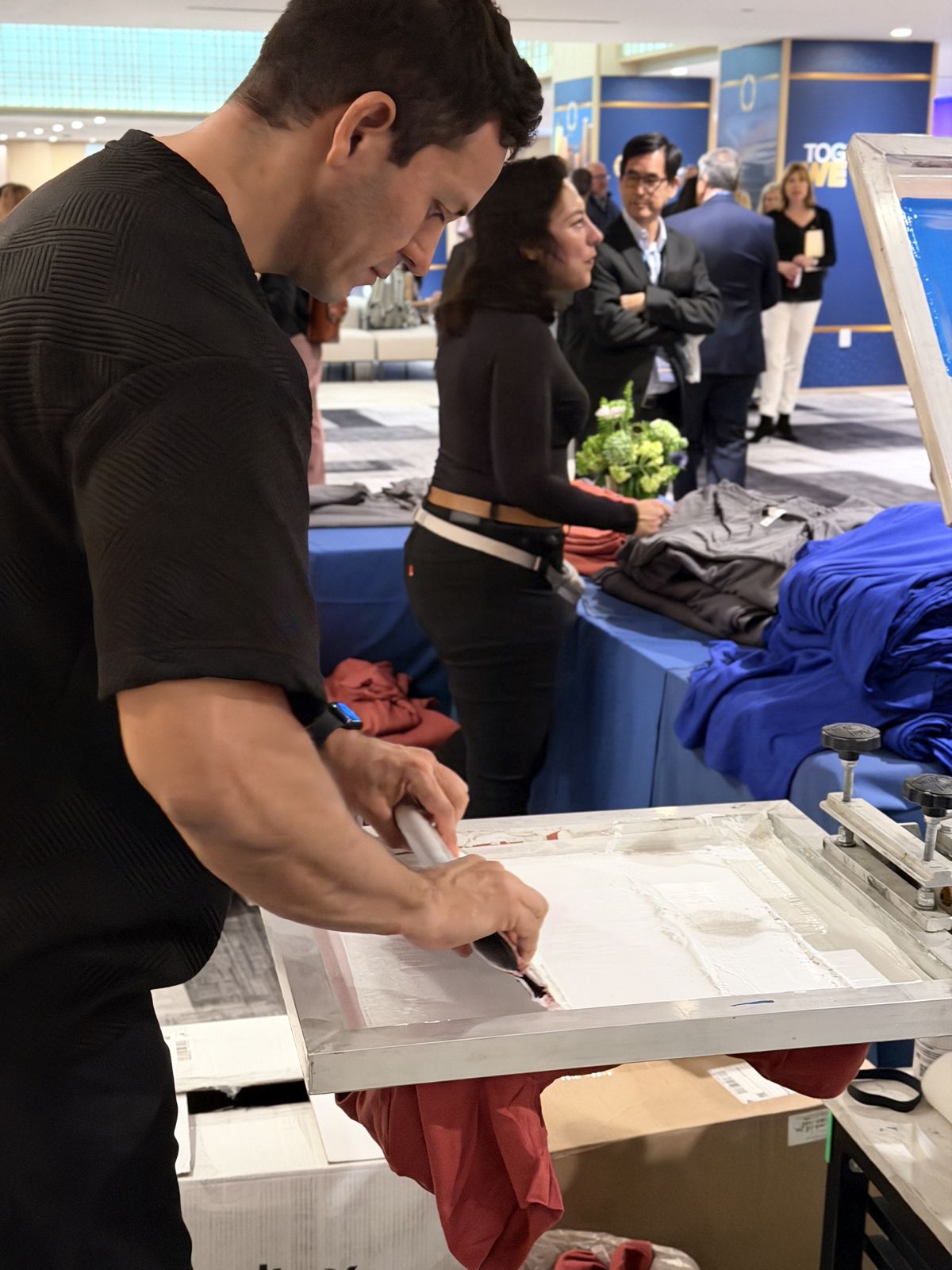 Merch Troop live printing — presses rolling at the event